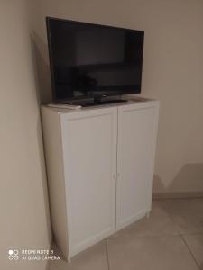 a television on top of a white entertainment center at sotto il Castello in Matera