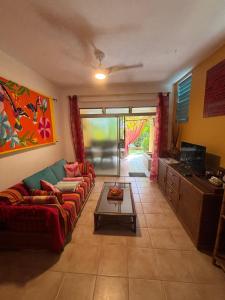 a living room with a couch and a table at L'Oasis de L'Anse Bleue in Le Diamant