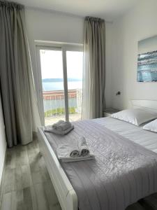 a bedroom with a bed with a view of the ocean at Accommodation Ventus 2 in Baška Voda