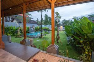 an external view of a garden with a swimming pool at Rana Suite in Ubud