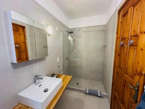 a bathroom with a sink and a shower at Villa Athena Skiathos in Megali Ammos