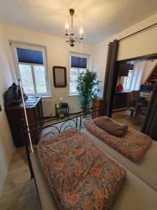 a bedroom with two beds and a table and windows at "Bedroo" Ferienwohnung am historischen Hafen in Wanfried +16 photos
