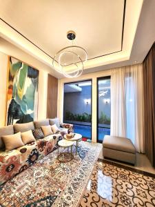 a living room with a couch and a table at The Alana Villas in Yogyakarta
