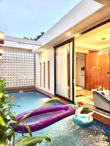 a pool in the middle of a house at The Alana Villas in Yogyakarta