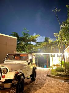 a white jeep parked on a brick driveway at The Alana Villas in Yogyakarta