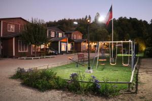 a park with a playground at night with a light at CABAÑAS AIRES DE MAROMILLAS in Constitución