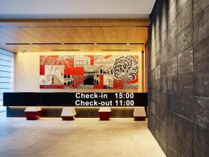 a lobby with a sign that reads check in at Mitsui Garden Hotel Ginza-gochome in Tokyo