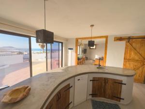 カレタ・デ・ファマラにあるBungalow Ahul Famara con pequeña piscinaのキッチン(海の景色を望むカウンター付)
