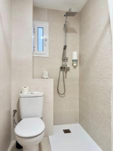 a bathroom with a toilet and a shower at El Jardin BeNerja in Nerja