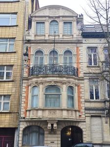 a building with a balcony on the side of it at Maison d'hôtes de Xavier in Brussels