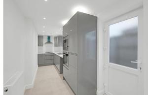 a kitchen with white walls and a large window at Northfield Home in Longbridge