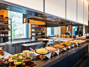 a buffet line with many different types of food at Mitsui Garden Hotel Ginza-gochome in Tokyo