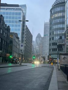 an empty street in a city with tall buildings at Small En-suite Shoreditch in London