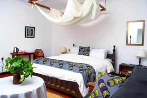 a bedroom with two beds and a couch at Ethiopian restaurant and lodge in Arusha