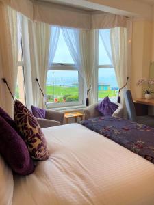 a bedroom with a large bed and a large window at The Briars in Paignton +23 photos