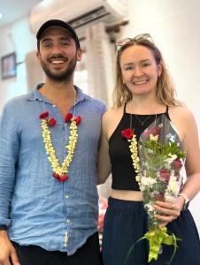 a man and a woman holding a bouquet of flowers at Reds Residency - Homestay in Cochin