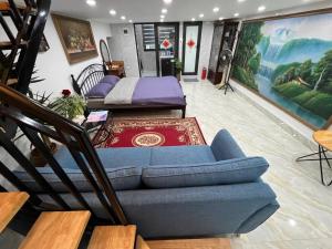 a living room with two beds and a couch at Sunny Balcony in Hanoi