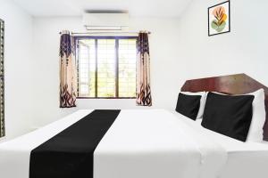 Voodi või voodid majutusasutuse Super Hotel O Kanyakumari Near Sunrise View formerly Jaisas Paradise toas