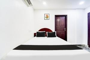 Voodi või voodid majutusasutuse Super Hotel O Kanyakumari Near Sunrise View formerly Jaisas Paradise toas
