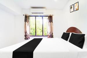 Voodi või voodid majutusasutuse Super Hotel O Kanyakumari Near Sunrise View formerly Jaisas Paradise toas