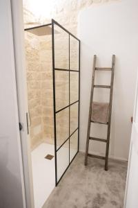 a ladder in a room with a glass partition at Zora loft&essence in Manfredonia