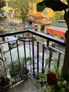 a balcony with potted plants and a view of a city at Sunny Balcony in Hanoi +12 photos