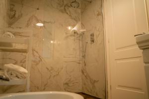 a bathroom with a shower and a sink at Locanda Gaudemus Boutique Hotel in Sistiana