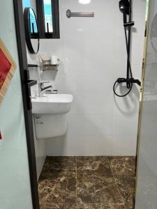 a bathroom with a sink and a mirror at Sunny Balcony in Hanoi