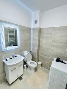 a bathroom with a white toilet and a sink at Gold House in Bucharest +24 photos