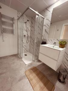 a bathroom with a shower and a sink at The white house in Villacosta