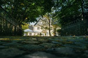 a white house with a fence in front of it at Relais & Châteaux Hotel Diepeschrather Mühle in Bergisch Gladbach