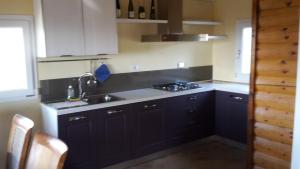 穆爾洛的住宿－Alba Chiara，厨房配有黑色橱柜和水槽