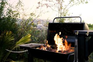 a barbecue grill with a fire in it at Yellow Egg in Cropthorne