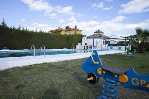 a blue and yellow toy airplane next to a swimming pool at Charming Villa in Linares with Private Pool in Jaén
