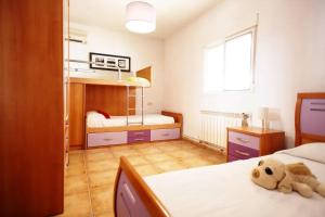 a bedroom with two beds and a stuffed teddy bear at Charming Villa in Linares with Private Pool in Jaén +56 photos
