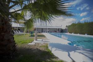 a swimming pool with a house in the background at Charming Villa in Linares with Private Pool in Jaén
