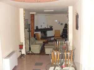 a living room with a table and a christmas tree at Zasheva Kushta Guesthouse in Bansko