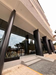 a building with black columns in front of it at Amazing and in the chic area in Tarija
