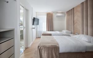 Łóżko lub łóżka w pokoju w obiekcie Hotel Maria