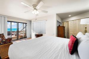 a bedroom with a white bed and a large window at Fanta-Sea 47 By Beachside Management in Siesta Key