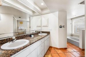 a white bathroom with two sinks and a tub at Fanta-Sea 47 By Beachside Management in Siesta Key +30 photos