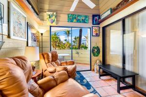 a living room with leather furniture and a table at Fanta-Sea 47 By Beachside Management in Siesta Key