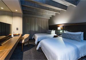 Ένα ή περισσότερα κρεβάτια σε δωμάτιο στο Movich Hotel Las Lomas