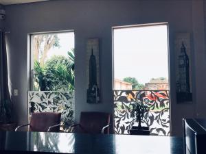 a dining room with a table and two windows at Cerrado Gran Hotel in Rio Verde +11 photos