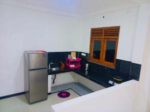 a kitchen with a black counter and a refrigerator at Villa South view Residence in Galle