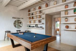 a living room with a pool table and shelves at O:live Villa Firenze in Lastra a Signa
