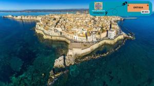 an island in the water with a city on it at Noto Barocca - HolidayHome in Noto +26 photos