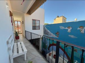a balcony with a mural on the side of a building at Casa Oaxaca in Oaxaca City