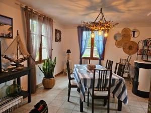 a dining room with a blue table and chairs at La maison de Jean in Saint-Riquier