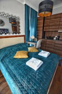 a bedroom with a bed with two towels on it at Villa Corleone in Kąty Wrocławskie +41 photos